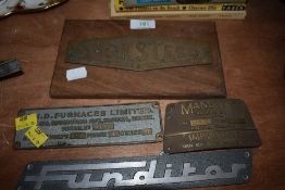 Four metal engineering/machinery signs and badges.