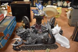 A collection of dragon ornaments, book ends and similar, seven items in total.