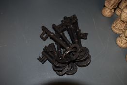 A collection of antique cut and wrought iron keys.