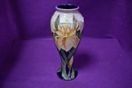 A Moorcroft baluster vase,having tube lined iris design in yellow on pink and blue ground designed