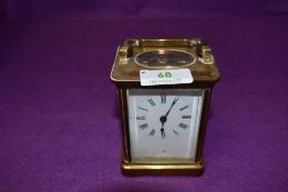 A brass cased French carriage clock having enamel face plate