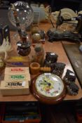 An assortment of items including a set of wooden owls, a wall clock, pipe and similar.