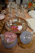 A selection of vintage Babycham advertising glasses and harleqin Arcopal tea cups and saucers