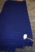 A finely knitted length of vintage navy blue wool having scalloped edges to the two finished