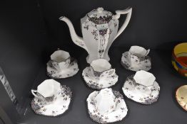 A Shelley 'Black leafy trees' part coffee service comprising of six Queen Anne shaped cups,six
