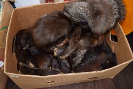 A collection of fur, including two fox fur stoles, mink hat and more.