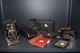 A selection of vintage cameras, including Vest pocket Kodak,Rollex vuiglander plate camera and