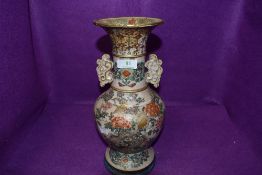 A large and imposing oriental vase possibly Japanese with earthen ceramic body decorated with