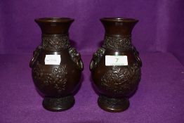 A pair of early 20th century Chinese bronze vases having decorative dragon Pattern to front and