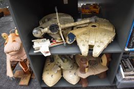 Two shelves of vintage Star Wars vehicles and accessories including two Millennium Falcons, Rebel