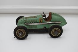 A Schuco Studio Tin Plate & Clockwork Mercedes Racing Car, model no 1050, in green having no 7