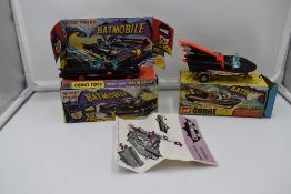 Two Corgi diecasts, Bat Mobile, with Batman and Robin figures present, on card display stand with