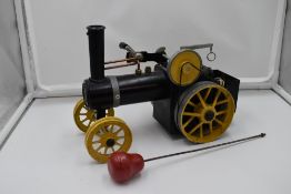 A Mamod Live Steam Traction Engine, having yellow wheels, missing canopy