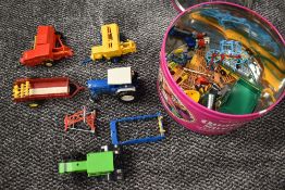 A collection of Britains play worn farm machines, tractors and accessories including Ford 6600,