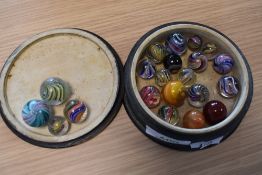 A collection of twenty one Victorian and later Glass Marbles of varying size, most having