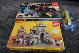 Two shelves of vintage Lego including Technics 8860 part set and King Castle 6080 part sets, both b
