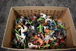 A box of Britains and similar plastic on metal stands Wild West, Military and similar figures and on