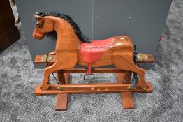 A modern wooden Rocking Horse on traditional swing action base