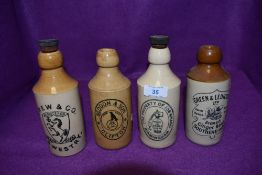 A selection of transfer printed earthen ware ginger beer bottles