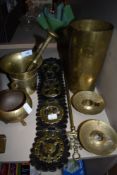 A selection of brass including matchbox holder, candle holders, horse brasses and shell casing.