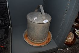 A vintage galvanized poultry drinker.