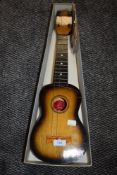 A boxed Ukulele small guitar and selection of audio postcards