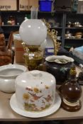 A selection of ceramics and lights including oil burning lamp cheese dome top and mirror