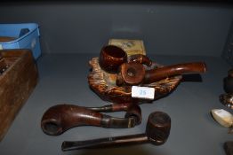 A selection of tobacco smokers pipes and rest including hand carved snake design pipe