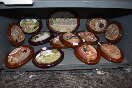 A collection of thirteen Lakeland studios wall plaques, including Ringtons tea interest.