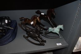 Four decorative metal rocking horses.