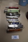 A selection of pocket and pen knives including Saynor and Swiss army style