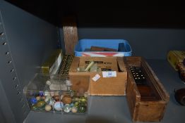 A selection of games and tokens including dominoes and marbles