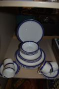 A selection of Royal porcelaine plates and cups and saucers,having blue band with gilt edging.