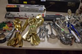 A selection of cutlery including yellow metal sets