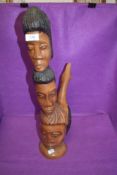 An exotic wood hand carved totem of figure heads