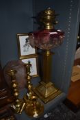 An impressive Victorian oil lamp having hand blown well with graduated cranberry glass also