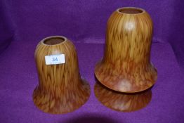 A set of three antique red and yellow mottled bell drop light shades