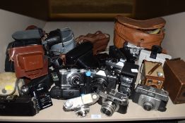 A selection of photography equipment and cameras including Praktica Halina and Paxette