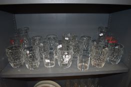 A selection of glass wares including beer pint glasses and water jugs