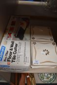 A Plasplugs tile cutter in box and some tiles.
