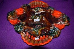 A Mid century studio pottery oyster/scallop or seafood platter, in orange, brown and blue hues.