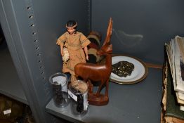 An assortment figurines and a wooden antelope and similar.