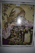 A framed needlepoint depicting young woman and floral scene.