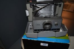 A Polaroid 320 Automatic Land camera in original box