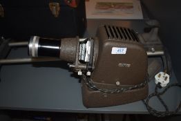 An Aldis slide projector, and sliding camera bed