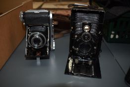 Two folding cameras, a Baldinette and a Vogtlander by Walter Talbot, Berlin