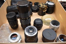 A box of various lenses including Ina 35mm, Mitakon Zoom 80-205mm, Chinon 50mm, Helios-44, Mertar