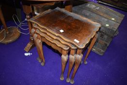 A nest of reproduction side table having quarter sawn flame veneer tops