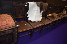 A set of six traditional oak dining chairs, having leather studded seats and interesting 'F' back,