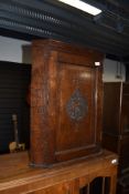 An oak corner cupboard of small proportions, having engraved front, L & R (M?)